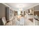 Elegant dining room with chandelier, tile flooring, and ample seating, adjacent to the kitchen and living area at 6821 Tierra Verde St, Port Richey, FL 34668