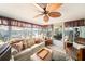 Inviting living room with a cozy couch and a unique leaf-bladed ceiling fan at 6821 Tierra Verde St, Port Richey, FL 34668