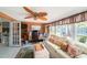 Comfortable living room with a cozy couch and a unique leaf-bladed ceiling fan at 6821 Tierra Verde St, Port Richey, FL 34668