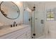Modern bathroom features a glass shower enclosure, sleek fixtures, and elegant finishes at 7120 3Rd N Ave, St Petersburg, FL 33710
