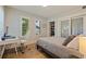 Bedroom includes a desk with a chair, closet with mirrored doors, and windows with plantation shutters at 7120 3Rd N Ave, St Petersburg, FL 33710