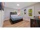 Serene bedroom featuring wood accents, shutters, and modern lighting, perfect for relaxation at 7120 3Rd N Ave, St Petersburg, FL 33710