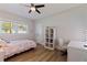 Cozy bedroom with wood flooring, ample natural light, and a dedicated study space at 7120 3Rd N Ave, St Petersburg, FL 33710