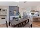 Dining room featuring a dark-wood table and bench with a kitchen and gray accent wall in the background at 7120 3Rd N Ave, St Petersburg, FL 33710