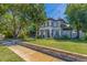 Well-maintained front yard with lush lawn, stone borders, and mature trees surrounding a beautiful two-story home at 7120 3Rd N Ave, St Petersburg, FL 33710