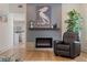 Comfortable living room with fireplace, plush armchair, and neutral tones creating a relaxing retreat at 7120 3Rd N Ave, St Petersburg, FL 33710