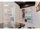 Walk-in pantry features open shelving and designer tile flooring and a view into the eat-in kitchen at 7120 3Rd N Ave, St Petersburg, FL 33710