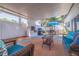 Relaxing outdoor patio area equipped with a built-in grill, dining set, and comfortable seating for entertaining at 7120 3Rd N Ave, St Petersburg, FL 33710