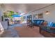 Relaxing covered patio features comfortable seating and dining with a view of the backyard at 7120 3Rd N Ave, St Petersburg, FL 33710