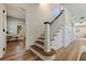 View of the staircase showing the dark-stained wood treads and a white riser, banister, and post at 7120 3Rd N Ave, St Petersburg, FL 33710