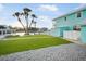 Waterfront home with manicured lawn, canal view, and a shed at 744 Spanish Main Dr, Apollo Beach, FL 33572