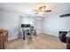 Bright room featuring a ceiling fan, a window with curtains, and a workspace with a desk, chair, and dual monitors at 744 Spanish Main Dr, Apollo Beach, FL 33572
