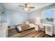 This serene bedroom is bathed in natural light, highlighting the wood laminate flooring and neutral color scheme at 744 Spanish Main Dr, Apollo Beach, FL 33572