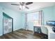 Cozy bedroom with desk, large window, modern decor, wood laminate flooring, and built-in storage at 744 Spanish Main Dr, Apollo Beach, FL 33572