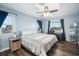 Bright bedroom with two windows, ceiling fan, light blue walls, and wood laminate flooring at 744 Spanish Main Dr, Apollo Beach, FL 33572