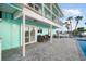 Two-story waterfront home with pool, patio seating, balcony, and canal views at 744 Spanish Main Dr, Apollo Beach, FL 33572