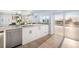 Elegant kitchen with white cabinetry, stainless steel appliances, and granite counters with access to outdoor pool at 744 Spanish Main Dr, Apollo Beach, FL 33572