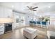 Open-concept kitchen with white cabinets, stainless steel appliances, and counter seating with backyard access at 744 Spanish Main Dr, Apollo Beach, FL 33572