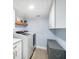Bright laundry room with a modern washer and dryer, floating shelf, cabinets, and a convenient folding station at 744 Spanish Main Dr, Apollo Beach, FL 33572