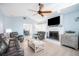Bright living room with tile floors, vaulted ceilings, ceiling fan, a fireplace, and comfortable leather seating at 744 Spanish Main Dr, Apollo Beach, FL 33572