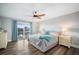 Bright main bedroom with a ceiling fan, sliding glass doors, and two nightstands with lamps at 744 Spanish Main Dr, Apollo Beach, FL 33572