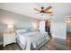 Bright main bedroom with a ceiling fan, barn closet doors, and two nightstands with lamps at 744 Spanish Main Dr, Apollo Beach, FL 33572