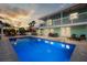 Inviting backyard oasis with pool, outdoor kitchen, multiple seating areas, and two-story home at 744 Spanish Main Dr, Apollo Beach, FL 33572