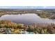 Scenic aerial view of lakefront property with lush trees and stunning water views at 7740 Blue Spring Dr, Land O Lakes, FL 34637