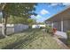 A serene backyard featuring a lush lawn, privacy fence, and manicured landscaping at 7740 Blue Spring Dr, Land O Lakes, FL 34637