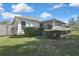 Charming home with a serene backyard, white fence, and lush landscaping at 7740 Blue Spring Dr, Land O Lakes, FL 34637