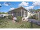 Charming backyard with a screened-in patio and manicured landscaping, creating an inviting outdoor space at 7740 Blue Spring Dr, Land O Lakes, FL 34637
