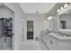 Transitional walk-in closet leads to a bathroom with double sinks and vanity at 7740 Blue Spring Dr, Land O Lakes, FL 34637