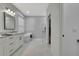 Elegant bathroom with modern soaking tub, a glass shower, and access to a closet at 7740 Blue Spring Dr, Land O Lakes, FL 34637