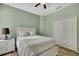 Bedroom with green walls, a ceiling fan, and a closet with lots of light at 7740 Blue Spring Dr, Land O Lakes, FL 34637