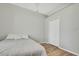 Cozy bedroom with a wood floor, a simple bed, and a white closet door at 7740 Blue Spring Dr, Land O Lakes, FL 34637