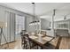 Dining room with a wood table, modern lighting fixture and an open design to living areas at 7740 Blue Spring Dr, Land O Lakes, FL 34637