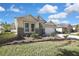Landscaped front yard of a single-story home with stone accents and a two-car garage at 7740 Blue Spring Dr, Land O Lakes, FL 34637