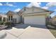 Well-maintained home featuring a two-car garage and decorative stone accents at 7740 Blue Spring Dr, Land O Lakes, FL 34637