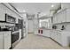 Bright kitchen with white cabinets, stainless steel appliances, and neutral countertops at 7740 Blue Spring Dr, Land O Lakes, FL 34637
