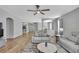Expansive living area featuring hardwood floors and seamless flow to the dining room at 7740 Blue Spring Dr, Land O Lakes, FL 34637
