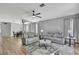Spacious living room boasting hardwood floors and an open layout to the dining area at 7740 Blue Spring Dr, Land O Lakes, FL 34637