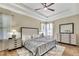 Spacious bedroom with tray ceilings, wood flooring, and bright natural light at 7740 Blue Spring Dr, Land O Lakes, FL 34637