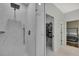 Glass shower with gray fixtures provides access to a closet and a bedroom at 7740 Blue Spring Dr, Land O Lakes, FL 34637