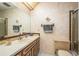 A full bathroom featuring a single sink vanity, toilet, and shower behind a glass door at 9910 Eagles Point Cir # 3, Port Richey, FL 34668