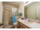 Neutral bathroom features tiled shower with glass door, and vanity with built-in sink at 9910 Eagles Point Cir # 3, Port Richey, FL 34668