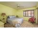 Bright bedroom with carpeted floors, a ceiling fan, and large sunlit window at 9910 Eagles Point Cir # 3, Port Richey, FL 34668