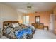 Comfortable bedroom featuring patterned bedding, wood furniture, and ensuite bath at 9910 Eagles Point Cir # 3, Port Richey, FL 34668