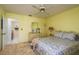 Comfortable bedroom with ensuite bath featuring carpeted floors and a ceiling fan at 9910 Eagles Point Cir # 3, Port Richey, FL 34668