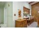 Hallway entrance with view of breakfast bar featuring wood paneled walls at 9910 Eagles Point Cir # 3, Port Richey, FL 34668