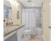 Bathroom vanity with granite countertop, framed mirror, shower and bathtub with white curtain at 1002 S Harbour Island Blvd # 1312, Tampa, FL 33602